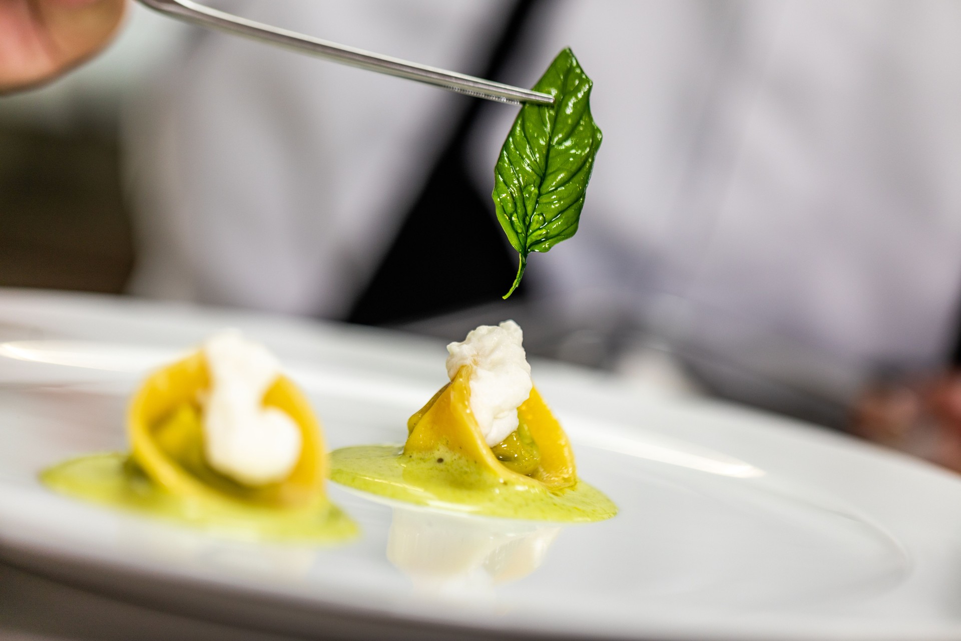 Decorating small bite-sized pasta dish using basil